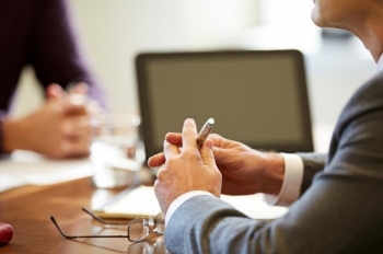 Financial Avisors hands on a conference table